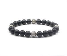 This bracelet features 8mm matte black onyx beads accented with three handmade 8 mm sterling silver Bali beads. We use silicon stretch cord for greater strength and resilience. Your bracelet comes in a bracelet gift box. Select your wrist measurement from the drop down menu. We will make your bracelet to fit. Check out our other men's bracelets: https://www.etsy.com/shop/KartiniStudio?section_id=16866421&ref=shopsection_leftnav_1 Allow 4-7 days delivery time. Classic Black Bracelets With 8mm Beads, Black Onyx 8mm Bead Jewelry, Black Onyx 8mm Beads Jewelry, Black Onyx Jewelry With 8mm Beads, Classic Black Beaded Bracelets, Classic Black Onyx Bracelets, Black Onyx 8mm Beads, Elegant Black Jewelry With 8mm Beads, Classic Black Onyx Bracelet