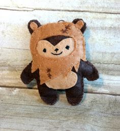 a stuffed animal with a bear on it's back sitting on a wooden surface