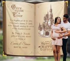 a pregnant couple standing in front of an open book with the words once upon a time printed on it