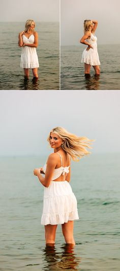 a woman standing in the water with her hair blowing back and looking into the distance