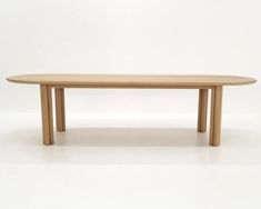 a wooden table sitting on top of a white floor