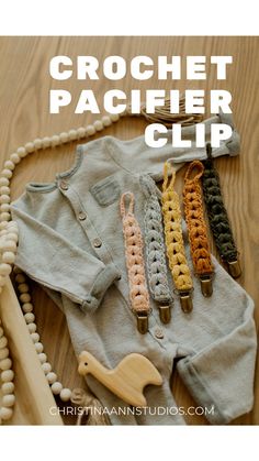 crochet pacifier clip is laying on top of a sweater