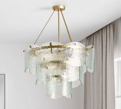 a chandelier hanging from a ceiling in a living room