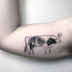 a man with a cow tattoo on his arm