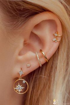 an ear with three different types of piercings on it, and one is in the middle