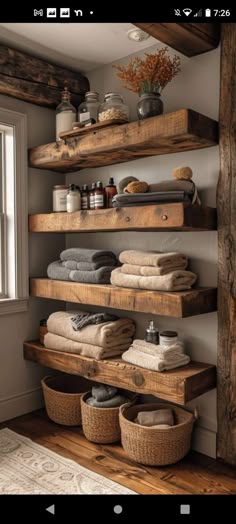 some shelves that have towels and other items on them in a room with wood flooring