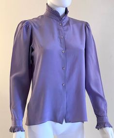 Vintage C1980s elegant, Victorian style, pure silk blouse in a gorgeous shade of lavender by Gloria Sachs, featuring a fully pleated collar and cuffs.  Front button closure. Approximate Measurements:      Bust: 36"; Waist: 36"; Length: 23"      Labeled a size 6 Pure quality and style, this C1980s Gloria Sachs blouse is in very good vintage condition, as shown; with some imperfections (see example in next to last photo). Formal Pleated Silk Blouse, Elegant Purple Silk Blouse, Silk Top With Ruffled Collar For Formal Occasions, Formal Silk Top With Ruffled Collar, Silk Tops With Ruffled Collar For Formal Occasions, Purple Silk Formal Blouse, Purple Silk Top For Formal Occasions, Formal Solid Color Blouse With Pleated Sleeves, Purple Silk Blouse For Workwear