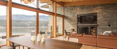 a living room filled with furniture and a fire place in front of a large window