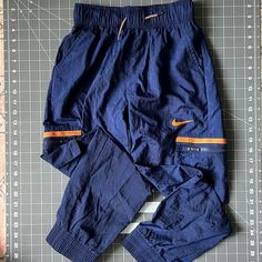 New, Never Worn Or Washed. Training Pants. Zipper Cargo Pockets To Keep Cash Safe! Blue Cotton Pants For Outdoor Activities, Blue Bottoms With Elastic Waistband For Outdoor Activities, Blue Cargo Pants With Side Pockets For Outdoor, Casual Blue Bottoms For Outdoor Activities, Casual Orange Joggers For Streetwear, Blue Pants With Elastic Waistband For Outdoor Activities, Orange Bottoms With Pockets For Outdoor, Blue Cotton Bottoms For Outdoor Activities, Blue Sports Bottoms With Cargo Pockets