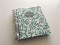 a blue and white notebook sitting on top of a table