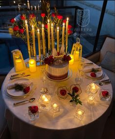 there is a cake with candles on it and many other items around the table that are lit up