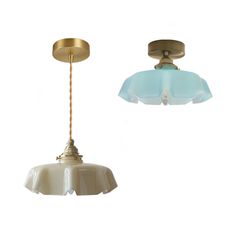 two light fixtures one with a blue glass shade and the other gold plated metal