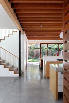 an open kitchen and living room with stairs