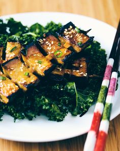 tofu and greens on a plate with chopsticks