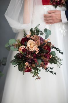 a bride and groom holding their bouquet