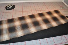 a tie laying on top of a cutting mat