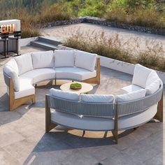 an outdoor seating area with round couches and tables