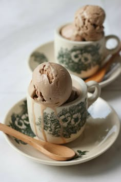 two cups filled with ice cream on top of a plate