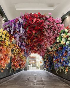 an archway covered in lots of colorful flowers