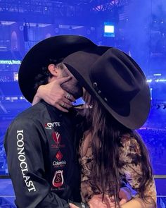 a man in a cowboy hat kissing a woman's face on the set of dancing with the stars