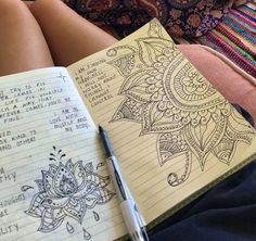 a notebook and pen sitting on top of a person's lap