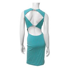 A fabulous turquoise stretch silk dress from Gianni Versace. From the front is it a simple fitted sleeveless dress. The back is dramatic and detailed in contrast with cut outs at the upper back and waist closing with silver metal clasps. The skirt portion is straight and is covered in the back with rows of small silver grommets. There is a side zipper and the back of the skirt in lined. Fits sizes Small, Medium. Marked Italian size 42. Bust Open Waist Open Hips 36-38" Length 38" Couture Evening Dress, Versace Couture, Versace Brand, Purple Mini Dresses, Runway Dresses, Purple Satin, Yellow Lace, Out Back, Wiggle Dress