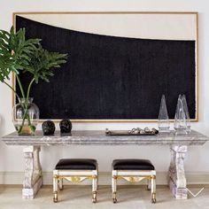 a table with two chairs and a blackboard behind it