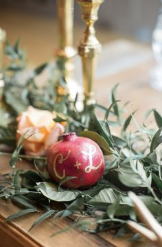 the table is decorated with greenery and gold candlesticks for an elegant touch