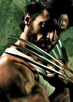 the wolverine character is posing with his hands on his chest and holding two large claws