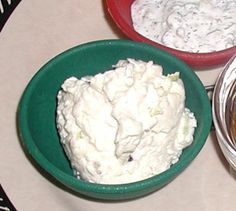 three bowls filled with food sitting on top of a table