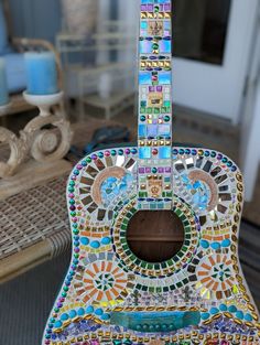 a colorful guitar sitting on top of a table