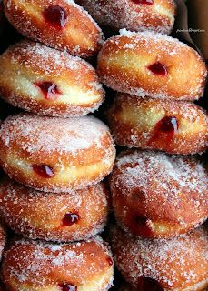 a box filled with donuts covered in powdered sugar