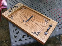 a wooden tray sitting on top of a metal table