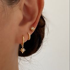 These Gorgeous dainty gold earrings are made of 925 sterling silver with 18k gold plated. They have beautifully crafted north star charms dangling from gold huggie hoop. Perfect for adding sparkle to your daily outfit. Beautifully go with the star stud earrings and basic gold huggies for ear stacking. A. Dangle earrings• Material: 18k Gold Plated on 925 sterling silver• Size: Length : 20mm , Hoop inner diameter: 8.5mm• Safe for sensitive skin• Can wear in the shower• Hypoallergenic, lead and nic Small Gold Dangle Earrings, Earring Inspiration Gold, Gold Jewelry For Hoco, Style Earrings, Dainty Gold Hoop Earrings, Gold Piercing Jewelry, Cute Dainty Ear Piercings, Gold Constellation Piercings, Dangly Earrings Gold