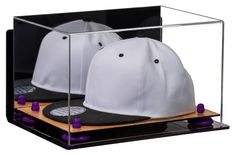 two hats are in a display case with purple caps on the front and back sides