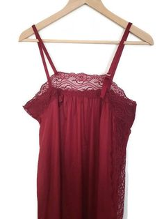 Vintage slip dress/ nightgown by Petra Fashions, RN 68223.  Made in the USA.  This lovely nightgown is made of burgandy/red 100% nylon fabric.  It features spaghetti strap shoulders and edged in wide lace along the bust, with a lace cut out side, giving elegance to this sleepwear. It is in very good vintage condition. There are no tears, snags or stains.  It measures 52" from shoulder to hem, and 35" around the bust. Sleeveless Coquette Nightgown With Built-in Bra, Coquette Sleeveless Nightgown With Built-in Bra, Red Spaghetti Straps Camisole For Sleep, Red Camisole Sleepwear For Night, Red Summer Camisole Nightgown, Red Spaghetti Strap Sleepwear For Wedding Night, Red Spaghetti Straps Sleepwear For Wedding Night, Red Sleeveless Sleepwear For Wedding Night, Red Camisole Nightgown For Loungewear