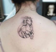 a woman with a tattoo on her back has a horse in the middle of it