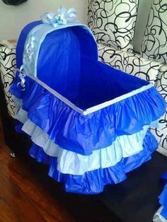 a baby's blue and white crib is sitting on the floor