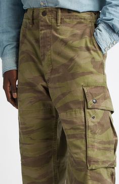 Washed and faded like a pair of old favorites, these cargo pants made of soft cotton feature a pale camo pattern and plenty of pockets for stowing essentials. 18 1/2" leg opening; 12" front rise; 17" back rise Zip fly with button closure Front slant pockets; coin pocket; back pockets; cargo flap-patch pockets Drawstring hems 100% cotton Machine wash, tumble dry Imported Designer Clothing Combat Style Cotton Cargo Jeans With Patch Pockets, Camouflage Cotton Tapered Leg Pants, Camouflage Cotton Tapered Leg Bottoms, Camouflage Straight Leg Cotton Cargo Jeans, Cotton Camouflage Tapered Leg Pants, Camouflage Tapered Leg Pants With Cargo Pockets, Camouflage Straight Leg Bottoms With Patch Pockets, Camouflage Cotton Pants With Side Pockets, Camouflage Cargo Pants With Tapered Leg