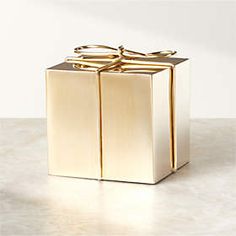 a gold gift box with two bows on it