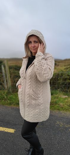 "Irish Aran Long Hooded Cardigan With Pockets - Cream/Oatmeal -Soft Merino Wool -100% Wool -2 Way Zipper -Really Warm&Chunky- MADE IN IRELAND A beautifully crafted Aran two-way zipper cardigan that's versatile, stylish and easy to wear. When our customers talk about this gorgeous Aran cardigan, the word we hear most is \"Love!\" They love the quality, they love the warmth and they love that it goes with just about everything! We love it for all those reasons too and it showcases the popular Aran Hooded Knitted Beige Cardigan, Beige Knitted Hooded Outerwear, Beige Knitted Hooded Cardigan, Beige Hooded Knitted Cardigan, Beige Hooded Knitted Outerwear, Aran Cardigan, Zipper Cardigan, Striped Blankets, Zippered Cardigan