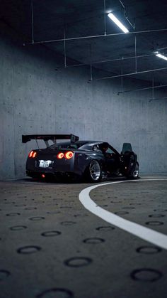 a black sports car parked in a parking garage