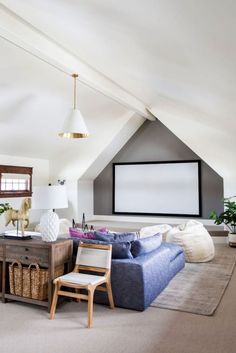 a living room filled with furniture and a flat screen tv mounted to the wall above it