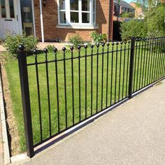 a black wrought iron fence in front of a house