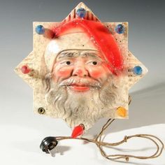 an old fashioned santa clause head on a white background with a red hat and blue eyes