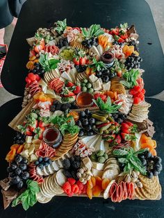 a platter filled with lots of different types of food on top of a table