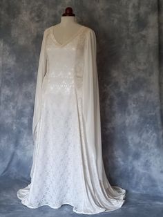 Medieval Wedding Dress, Elvish Wedding Dress, Handfasting Dress, Elvish Gown,  Renaissance Gown, Medieval Gown, Grace FREE TRACKABLE AND INSURED SHIPPING frockfollies is proud to add this beautiful new design to the collection. Grace is pictured in ivory guipure lace over satin and ivory crushed velvet. With it's elegant V shaped front and back neckline Grace is complimented by elegant flowing chiffon sleeves and back lacing. It has a really romantic, elegant feel.  The train can be made shorter at no extra cost. It is designed and custom made by Gill Linley of frockfollies. Perfect for so many occasions: Medieval, Renaissance, Elvish Weddings, Hand Fasting ceremonies, LARP events, Re Enactments, Masquerade Balls or your 'inner goddess' moments! Hand made in England by an experienced theat Elvish Wedding Dress, Wedding Dress Medieval, Elvish Dress, Handfasting Dress, Elvish Wedding, Elven Wedding Dress, Medieval Wedding Dress, Dress Medieval, Hand Fasting