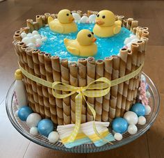 a cake decorated with rubber ducks in the water