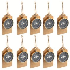 eight compass tags hanging from rope on white background