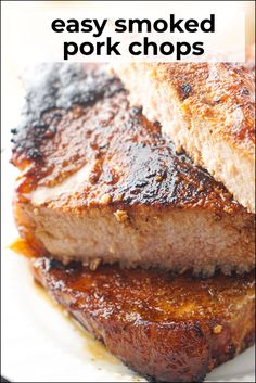 two pieces of meat sitting on top of a white plate with the words easy smoked pork chops